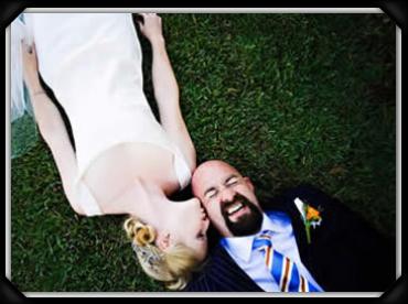 Edge Wedding couple laying on grass in an engagement photo